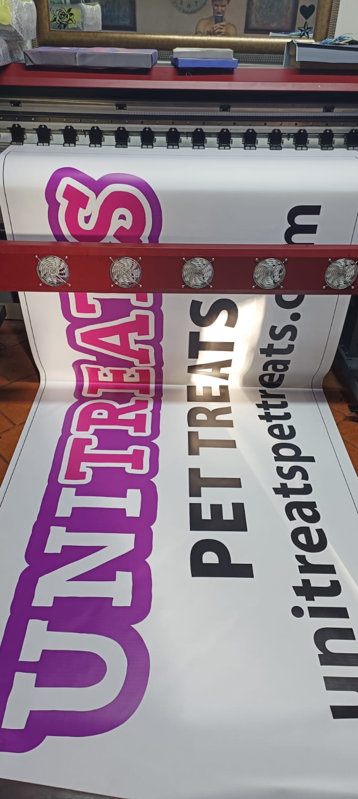 Unipet Pet Treats branded banner on printing machine